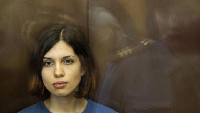A member of the female punk band &quot;Pussy Riot&quot; Nadezhda Tolokonnikova sits in a glass-walled cage during a court hearing in Moscow, August 17, 2012. A Russian ju