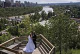 Novomanželé pózují u rozvodněné řeky Bow v Calgary.