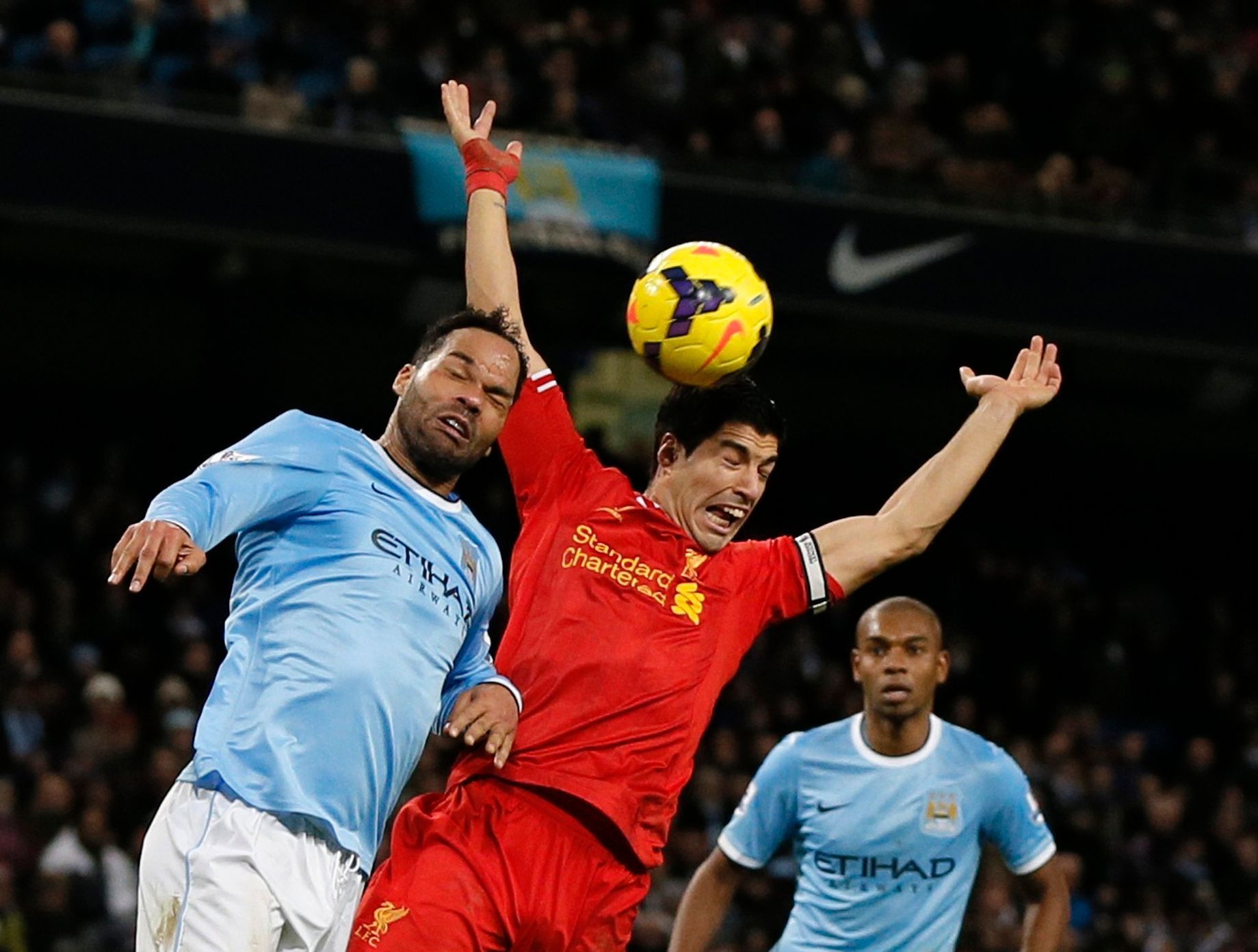 Liverpool's Suarez is challenged by Manchester City's Lescott during their English Premier League soccer match in Manchester
