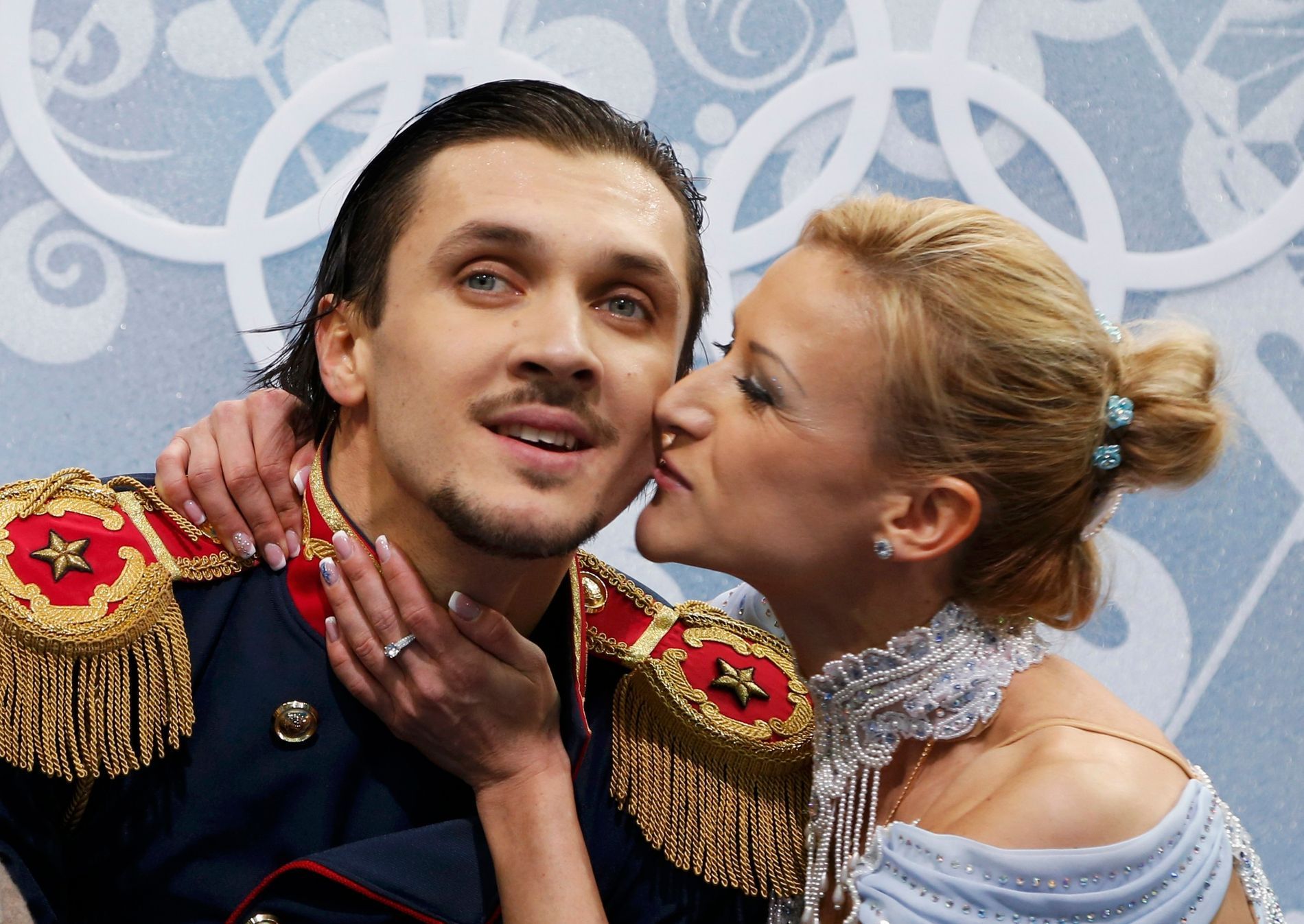 Russia's Tatiana Volosozhar kisses Maxim Trankov during the Figure Skating Pairs Short Program at the Sochi 2014 Winter Olympics