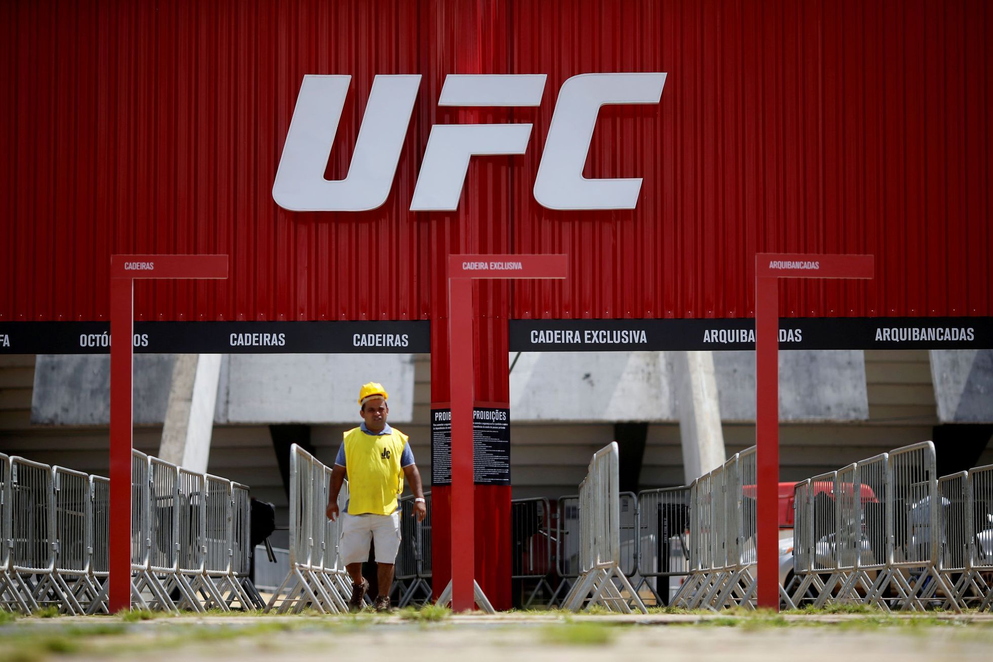 FILE PHOTO: A man walks in front of the Nilson Nelson Gymnasium as the next UFC Fight Night will be held without fans during the fights, after reports of the coronavirus in Brasilia