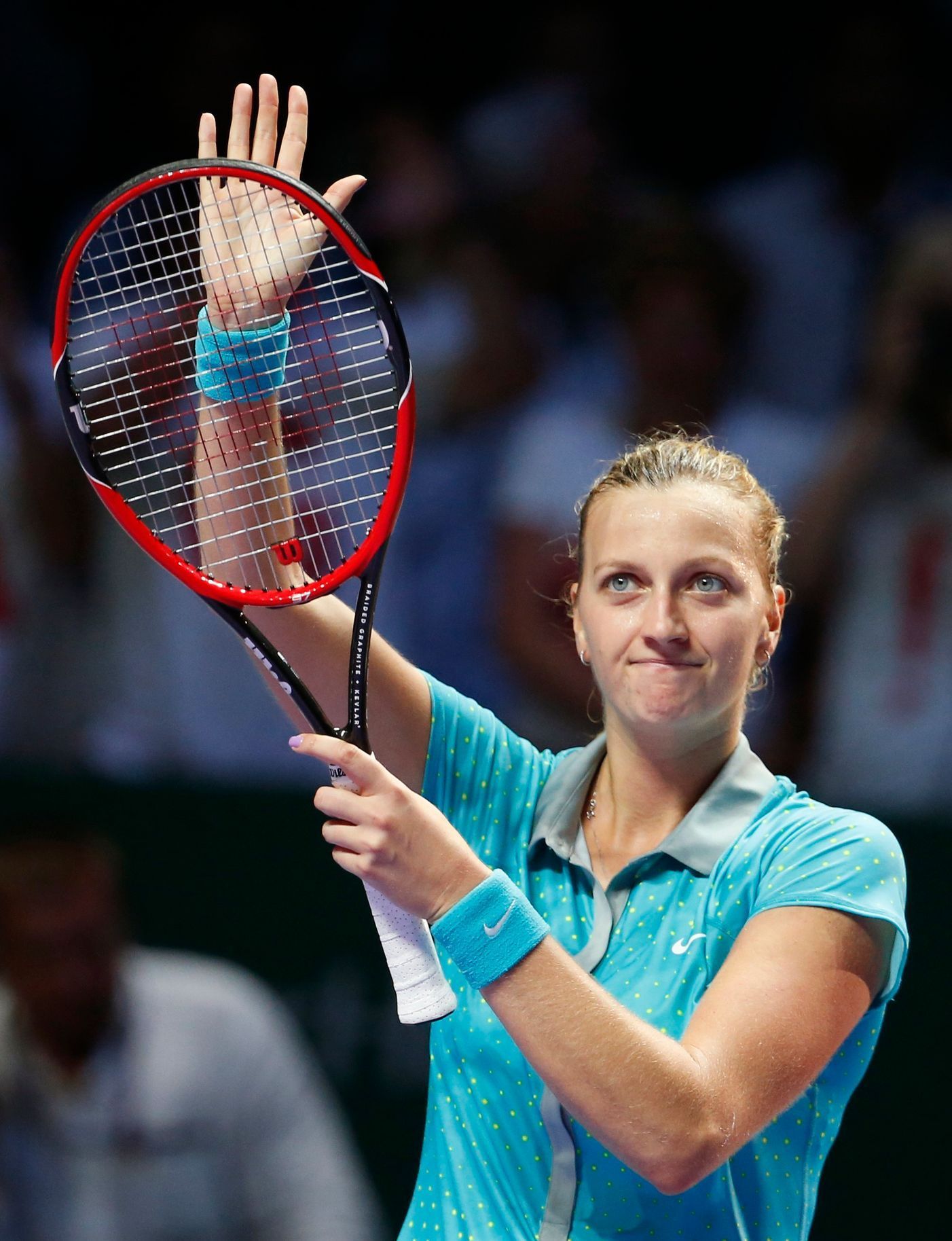 Petra Kvitova of the Czech Republic acknowledges the audience after defeating Maria Sharapova of Russia during their WTA Finals singles tennis match at the Singapore Indoor Stadium