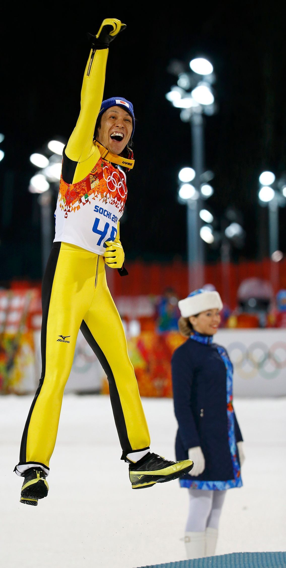 Second-placed Japan's Kasai celebrates during flower ceremony for men's ski jumping individual normal hill final event of Sochi 2014 Winter Olympic Games in Rosa Khutor