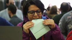 A woman prepares to cast her vote for the Andalusian regional elections at a polling station in in Seville