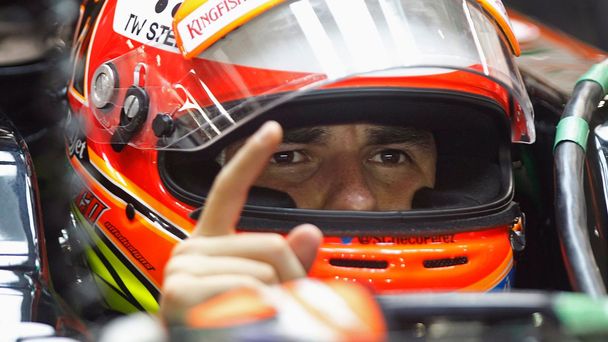 Force India Formula One driver Sergio Perez of Mexico gestures in his car during the second practice session of the Singapore F1 Grand Prix at the Marina Bay street circuit in Singapore