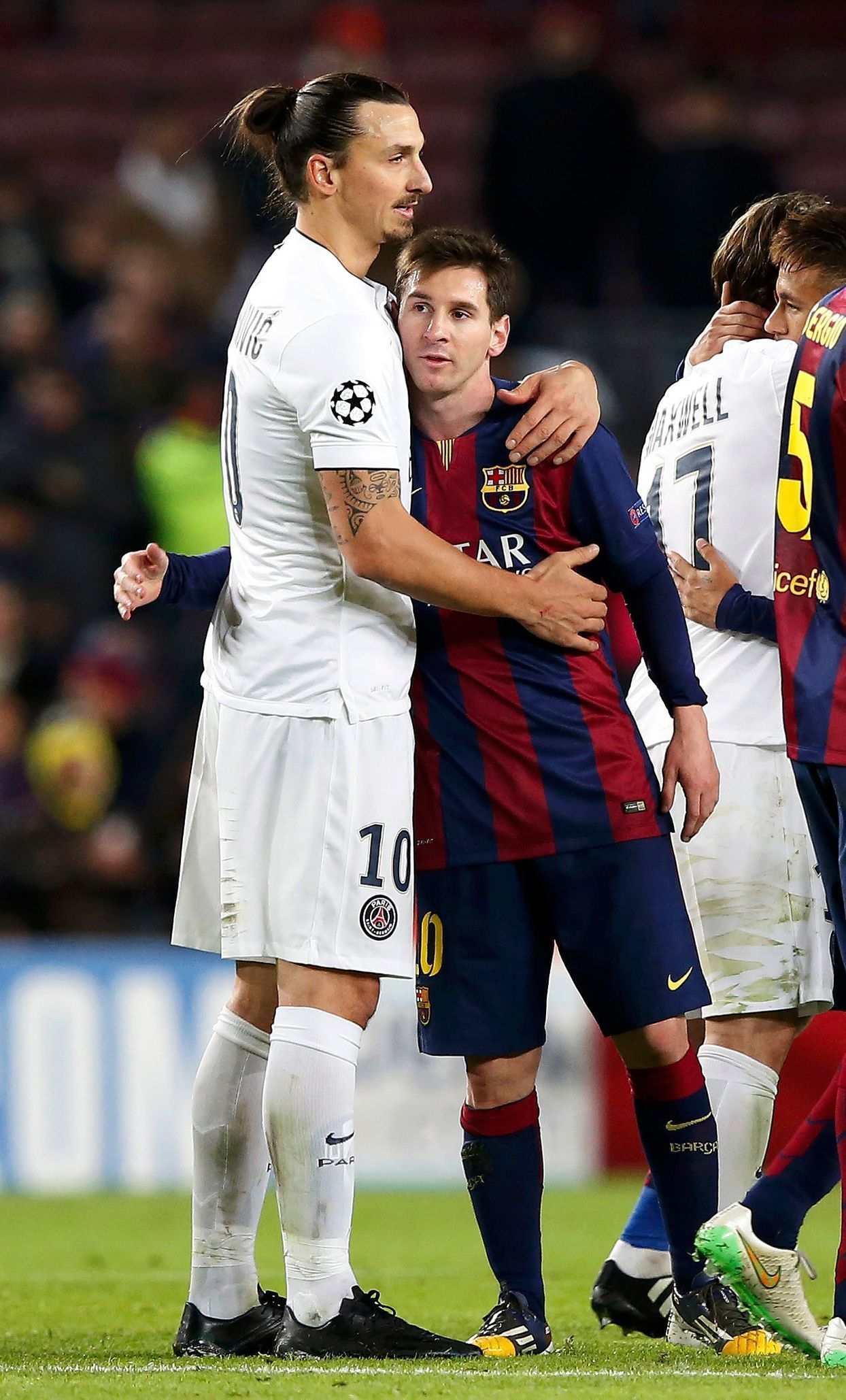Paris St Germain's Zlatan Ibrahimovic embraces Barcelona's Lionel Messi after their Champions League Group F soccer match at the Nou Camp stadium in Barcelona