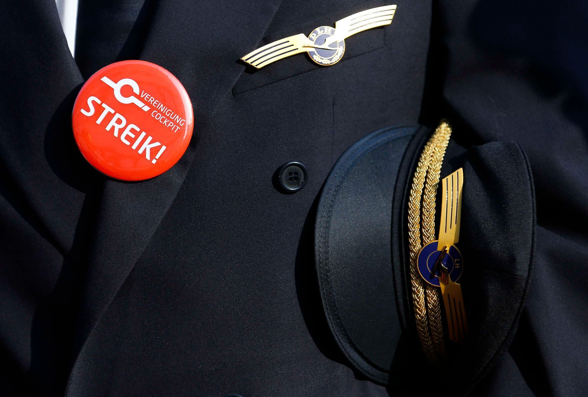 Lufthansa pilot wears badge reading &quot;strike&quot; on his uniform as he takes part in a demonstration at Fraport airport in Frankfurt