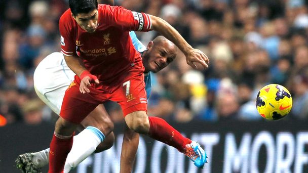 Liverpool's Suarez challenges Manchester City's Kompany during their English Premier League soccer match in Manchester