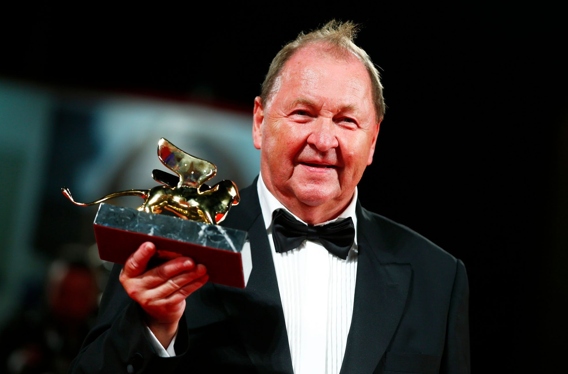 Swedish director Roy Andersson holds the Golden Lion prize for his movie &quot;A Pigeon Sat on a Branch Reflecting on Existence&quot; during the award ceremony at the 71st Venice Film Festival