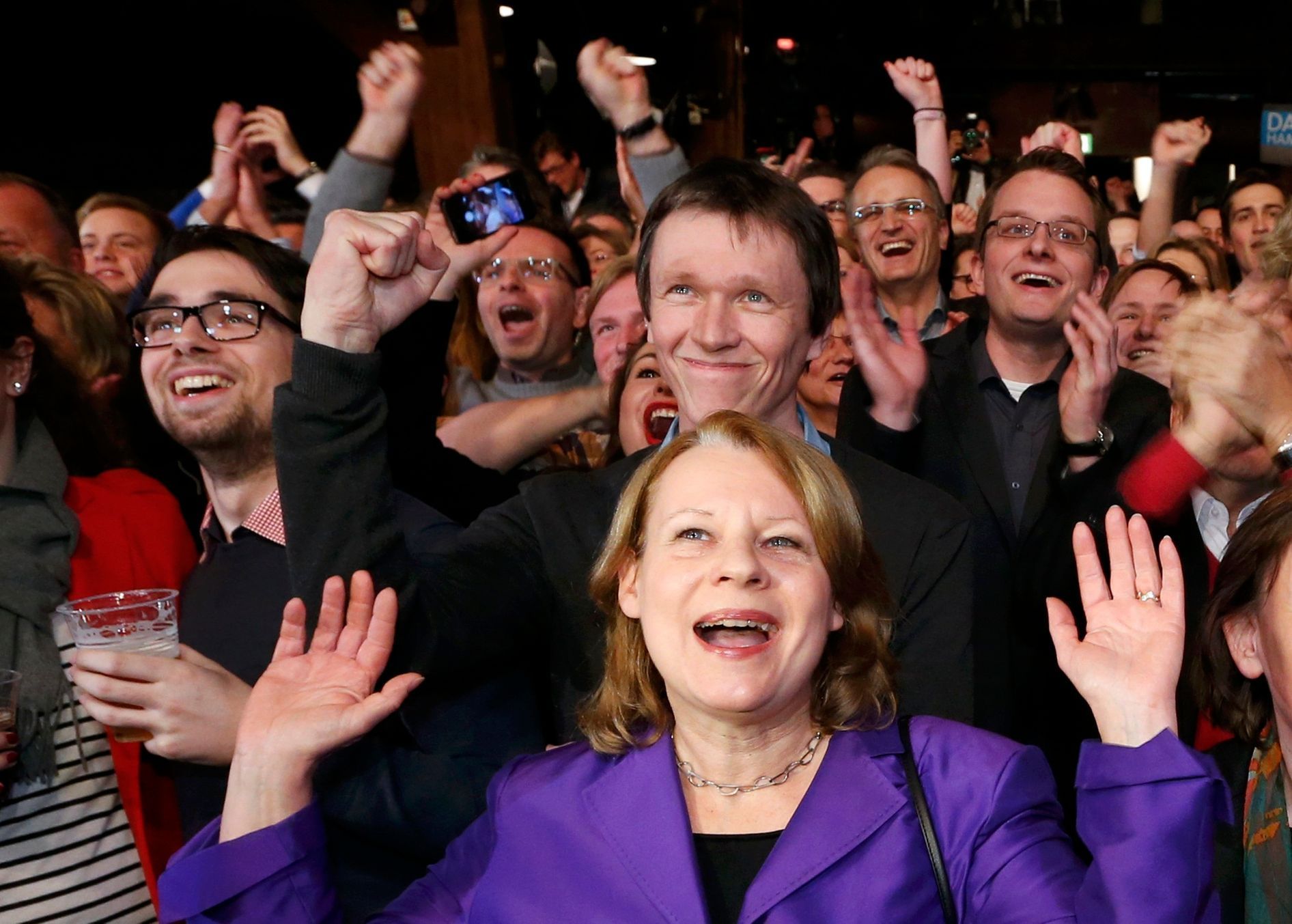 Members of the Social Democratic Party (SPD) react to the first exit polls in a state election in Hamburg