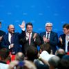 Schulz, candidate for European Commission president of Germany's SPD, gestures as he receives applause from SPD chairman Gabriel, Foreign Minister Steinmeier and other party members upon first exit po