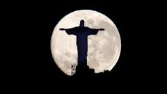 The supermoon is pictured behind the Christ the Redeemer statue in Rio de Janeiro