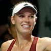 Wozniacki of Denmark prepares to hit balls to the audience after defeating Radwanska of Poland during their WTA Finals singles tennis match at the Singapore Indoor Stadium