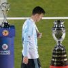 Argentina's Lionel Messi walks with his silver medal past the Copa America trophy during the presentation ceremony after Chile defeated his team in the Copa America 2015 final soccer match at the Nati