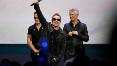 Bono of Irish rock band U2 gestures to the audience after performing at an Apple event at the Flint Center in Cupertino