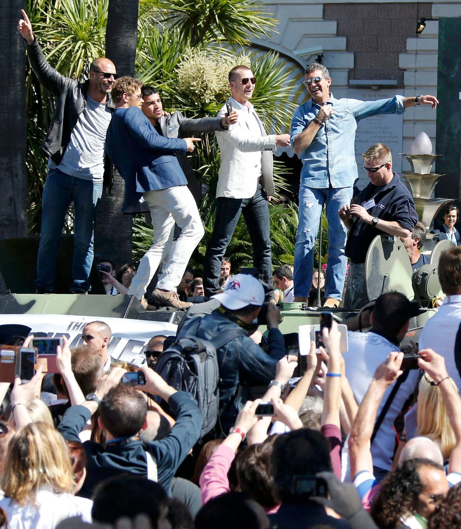 Cast members Randy Couture, Kellan Lutz, Victor Ortiz, Glen Powell and Antonio Banderas pose  on a tank as they arrive on the Croisette to promote the film &quot;The Expendables 3&quot; during the 67t