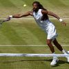 Dustin Brown of Germany hits a shot during his match against Viktor Troicki of Serbia at the Wimbledon Tennis Championships in London