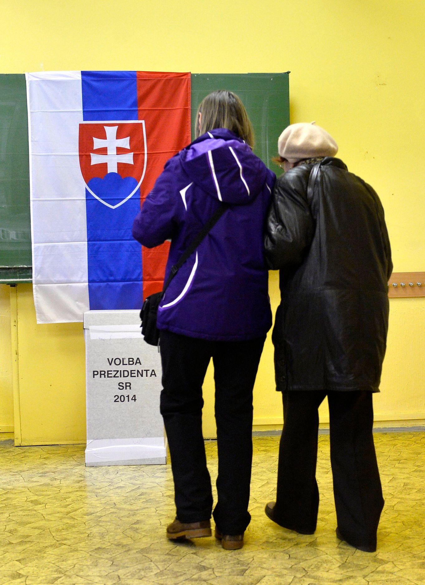 People cast their ballots at a polling station during the first round presidential elections in Bratislava