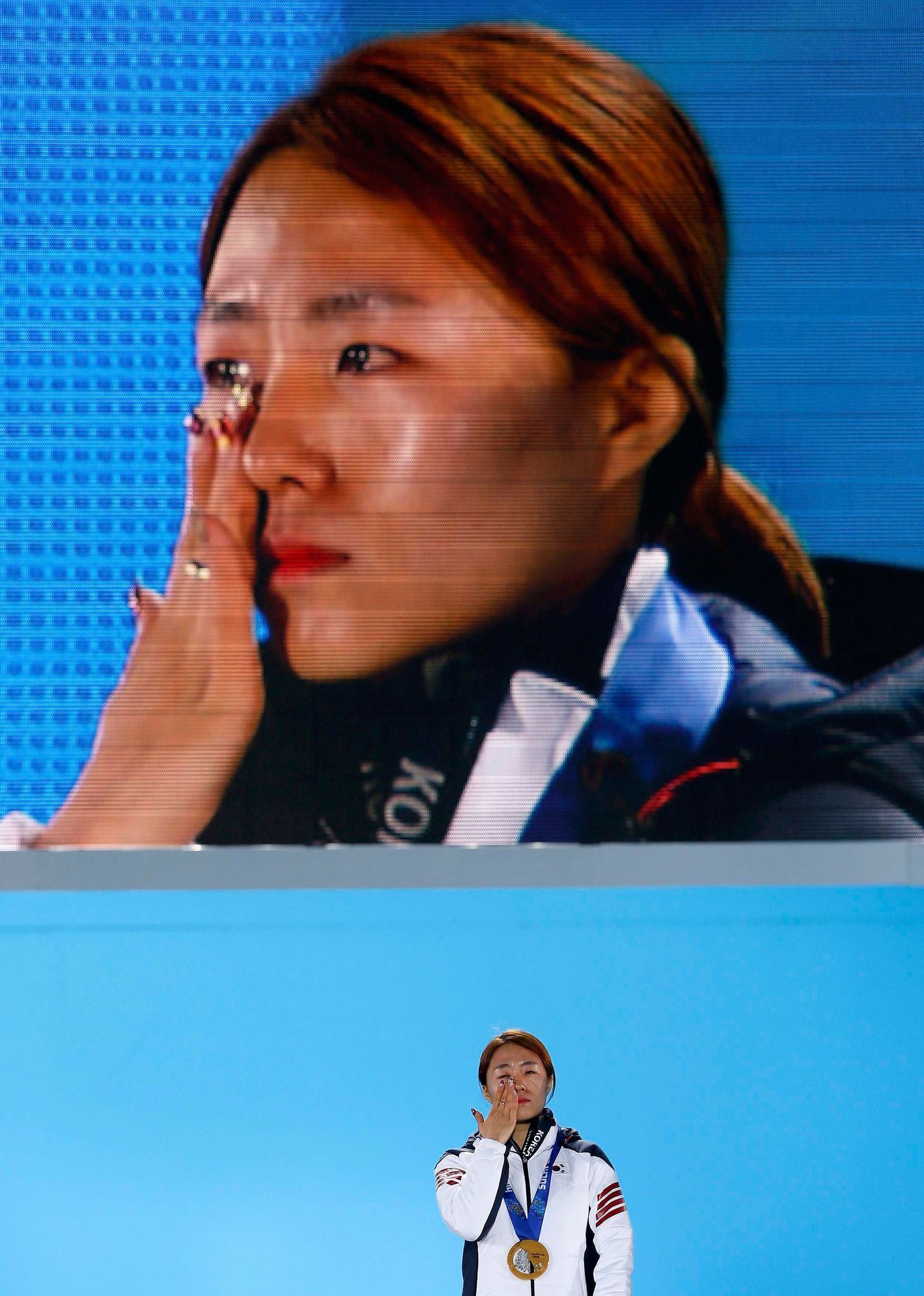 Gold medalist South Korea's Lee cries during the medal ceremony for the women's 500 meters speed skating competition at the Sochi 2014 Winter Olympic Games in Sochi