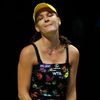 Radwanska of Poland reacts after losing a point against Kvitova of the Czech Republic during their WTA Finals singles tennis match at the Singapore Indoor Stadium