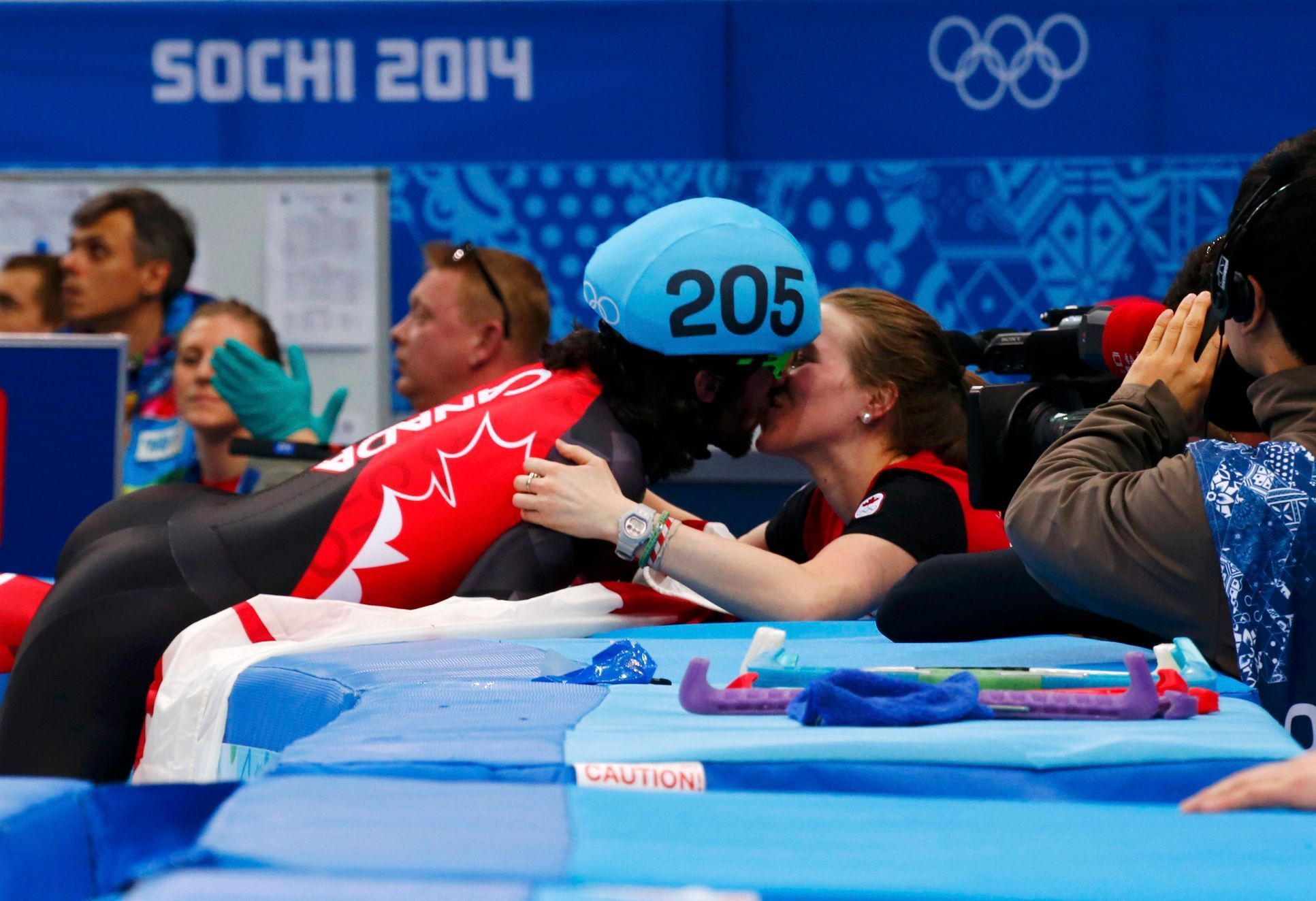 Canada's Charles Hamelin kisses his girlfriend and compatriot speed skater Marianne St-Gelais after winning the men's 1,500 metres short track speed skating race finals at the Iceberg Skating Palace d