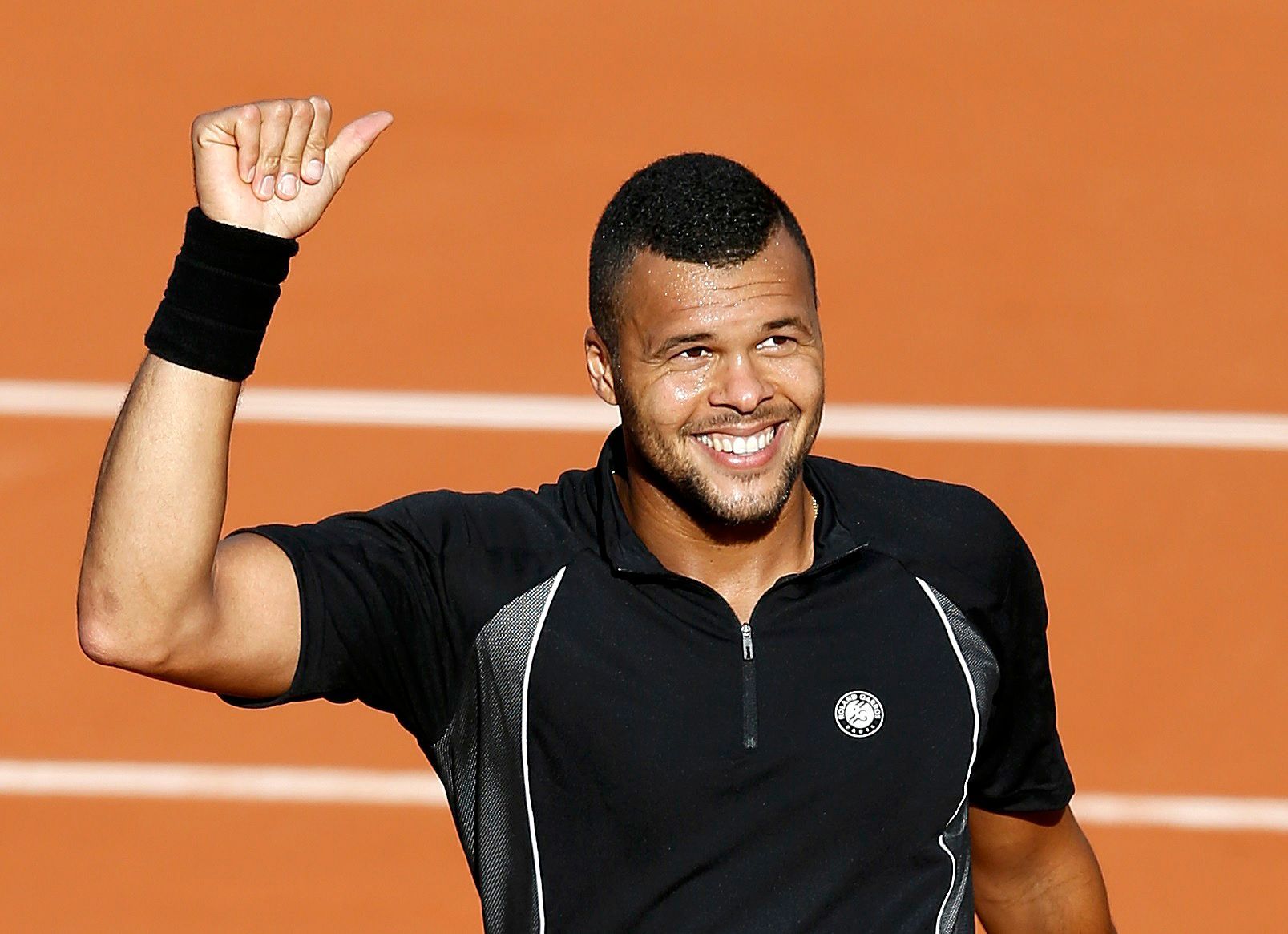 Jo-Wilfried Tsonga of France celebrates after beating Christian Lindell of Sweden during their men's singles match at the French Open tennis tournament at the Roland Garros stadium in Paris