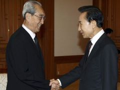 Někdejší jihokorejský prezident I Mjong-bak při setkání se členem delegace KLDR Kim Ki-namem.