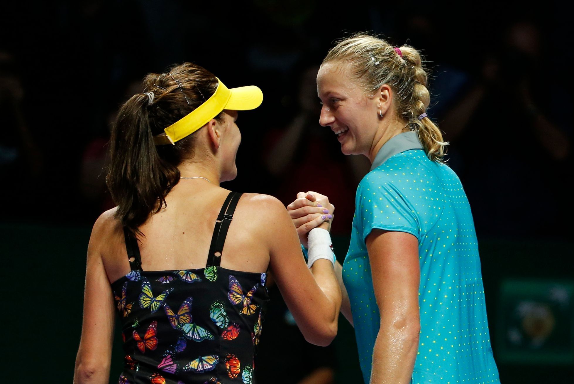 Radwanska of Poland is congratulated by Kvitova of the Czech Republic during their WTA Finals singles tennis match at the Singapore Indoor Stadium