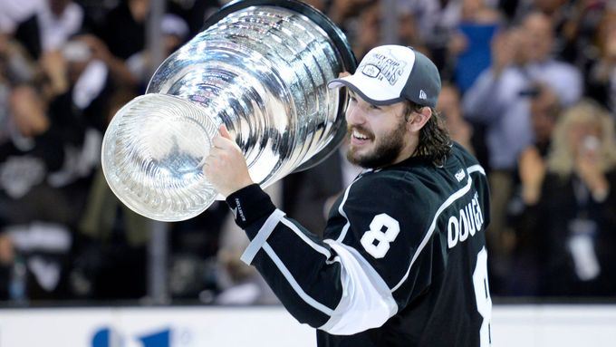 Jun 13, 2014; Los Angeles, CA, USA; Los Angeles Kings defenseman Drew Doughty (8) skates around the rink with the Stanley Cup after defeating the New York Rangers game fi