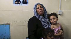 Relatives of Palestinians, whom hospital officials said were wounded by Israeli air strike, cry at hospital in Gaza City