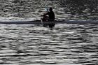 A man drinks a water as he rows a boat on the Vltava river in Prague