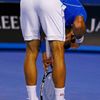 Djokovic of Serbia reacts after hurting his hand after trying to reach a return to Murray of Britain during their men's singles final match at the Australian Open 2015 tennis tournament in Melbourne