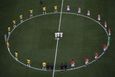 Brazil and Croatia players stand in a circle as doves (C) are released before kickoff at the 2014 World Cup opening match at the Corinthians arena in Sao Paulo June 12, 2