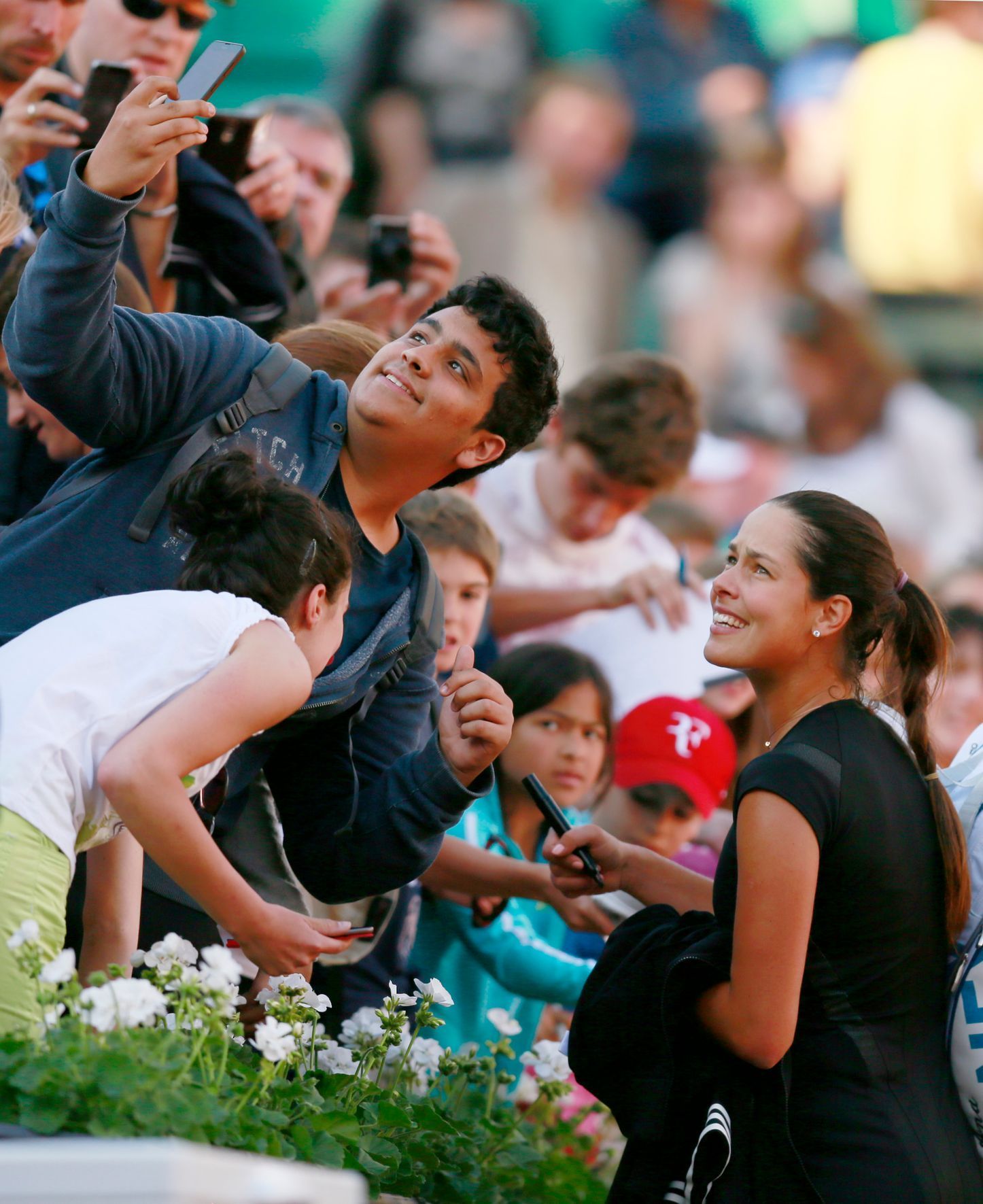 Tennis: Women's Singles - Serbia's Ana Ivanovic poses for a selfie with a fan after winning her first round match