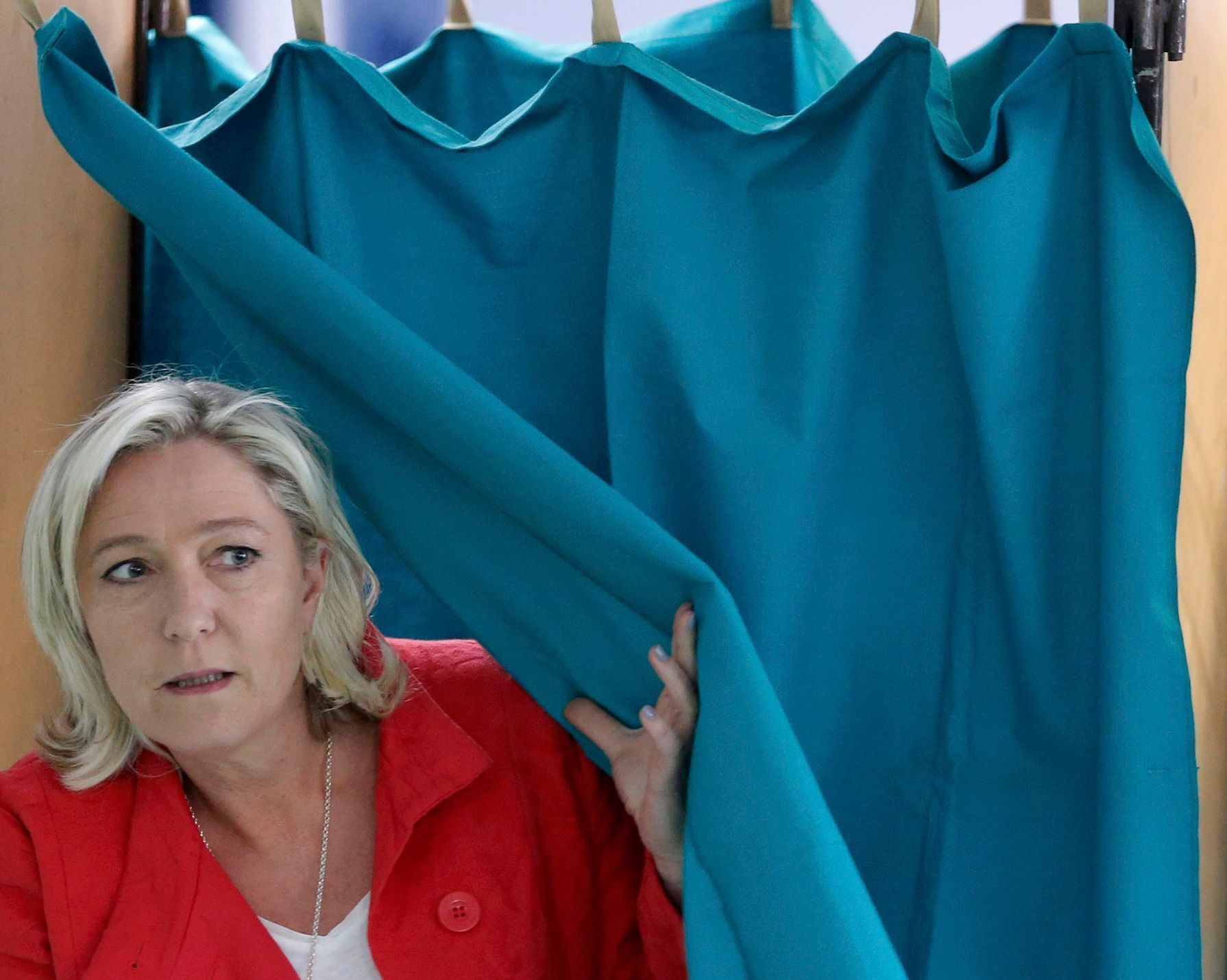Marine Le Pen, France's National Front political party head, leaves the polling booth before casting her ballot in the European Parliament election in Henin-Beaumont