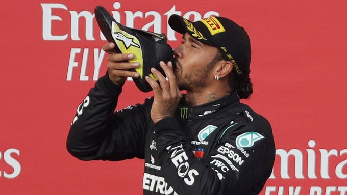 Lewis Hamilton pije z boty Daniela Ricciarda po závodě formule 1 v Imole