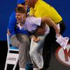 A line judge reacts as a protester is removed from the court by a security personnel during the men's singles final match between Djokovic of Serbia and Murray of Britain at the Australian Open 2015 t