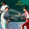 Second placed Mercedes Formula One driver Rosberg sprays champagne at compatriot Ferrari driver Vettel on the podium after the Australian F1 Grand Prix in Melbourne