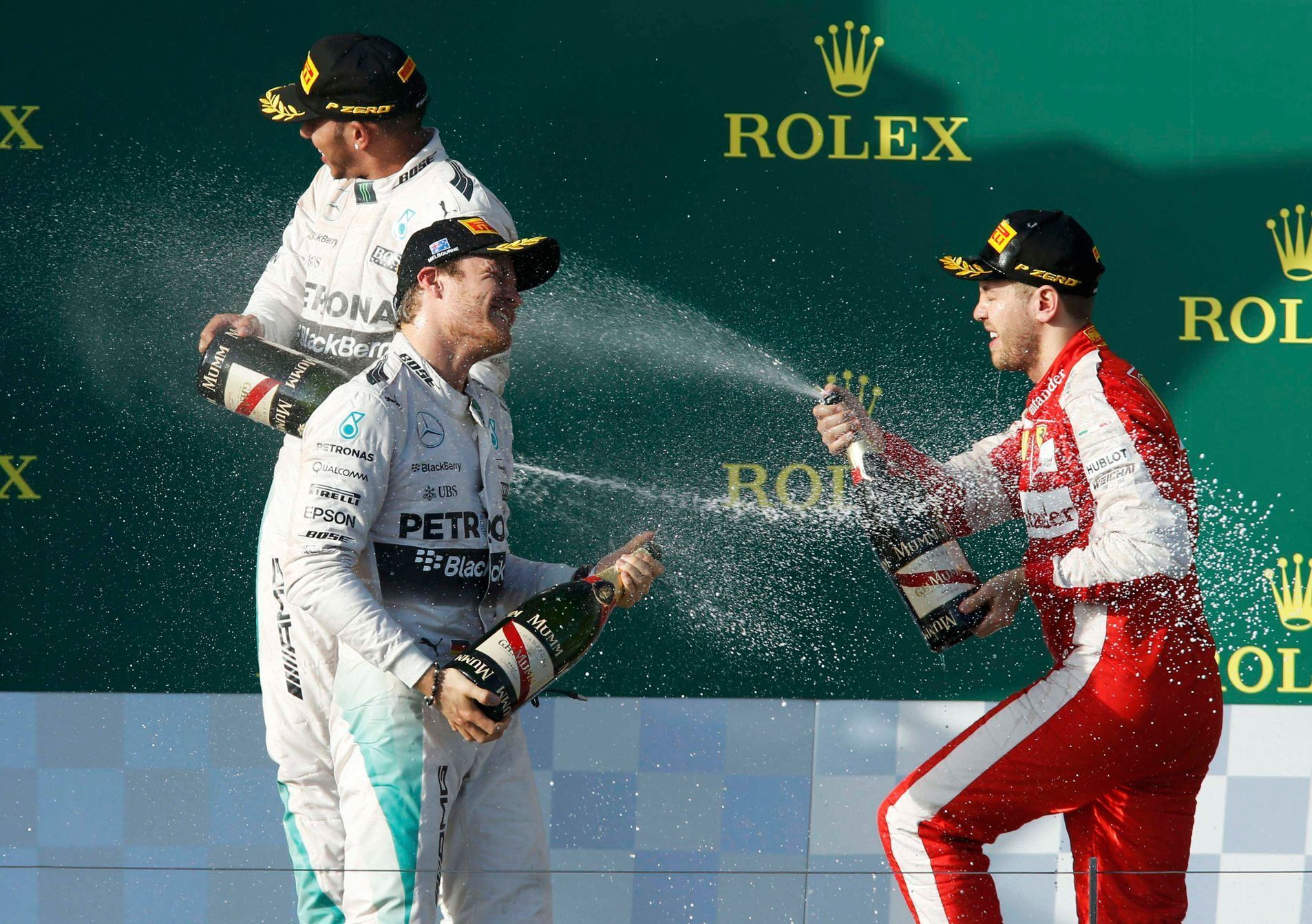 Second placed Mercedes Formula One driver Rosberg sprays champagne at compatriot Ferrari driver Vettel on the podium after the Australian F1 Grand Prix in Melbourne