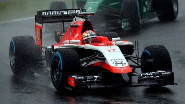 Marussia Formula One driver Bianchi of France drives in front of Caterham Formula One driver Kobayashi of Japan during the Japanese F1 Grand Prix at the Suzuka Circuit