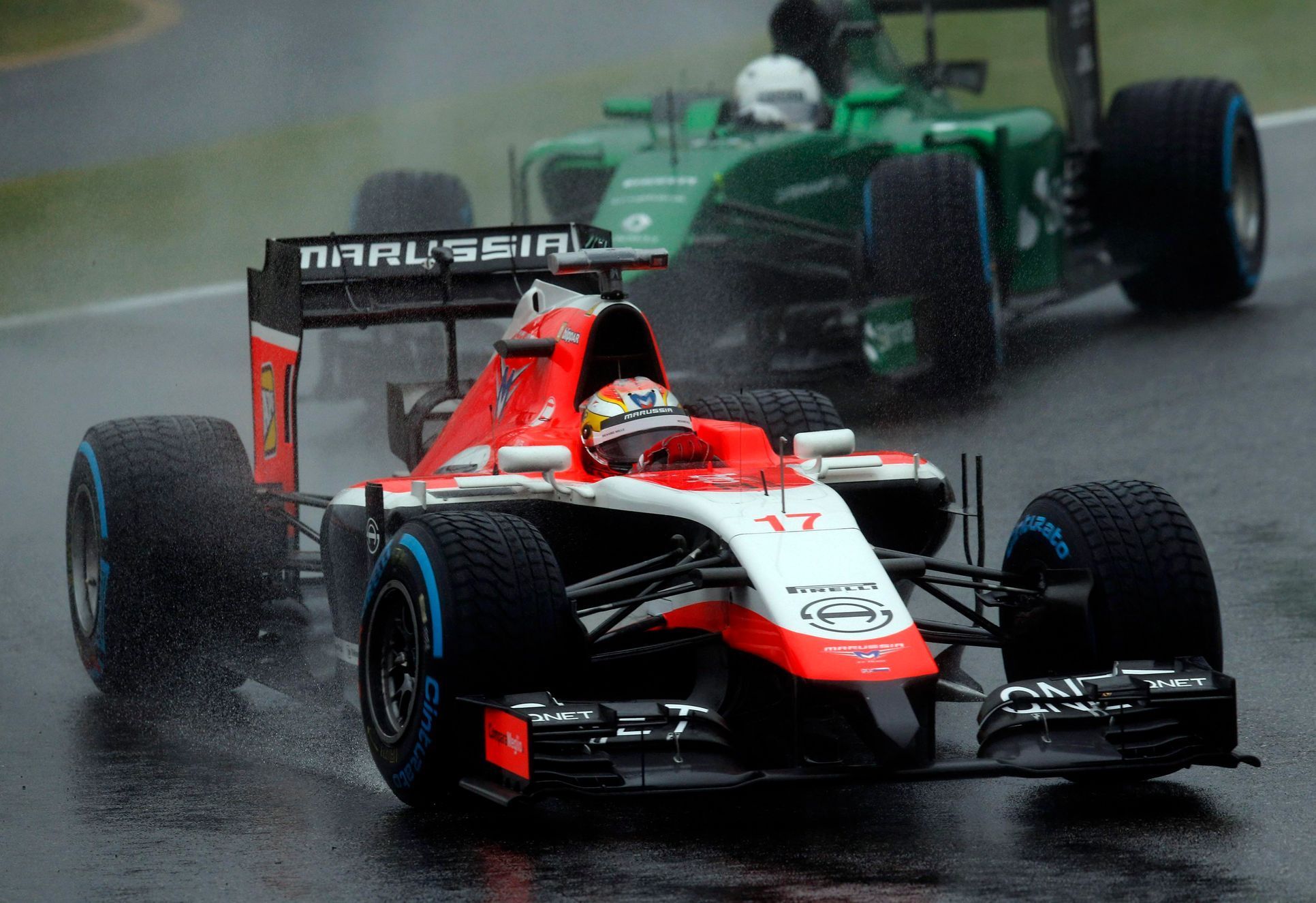 Marussia Formula One driver Bianchi of France drives in front of Caterham Formula One driver Kobayashi of Japan during the Japanese F1 Grand Prix at the Suzuka Circuit