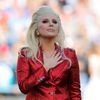 Lady Gaga places her hand over her heart after singing the U.S. National Anthem before the start of the NFL's Super Bowl 50 football game between the Carolina Panthers and the Denver Broncos in Santa