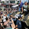 Cast members Sylvester Stallone, Dolph Lundgren, Harrison Ford and Jason Statham pose on a tank as they arrive on the Croisette to promote the film &quot;The Expendables 3&quot; during the 67th Cannes