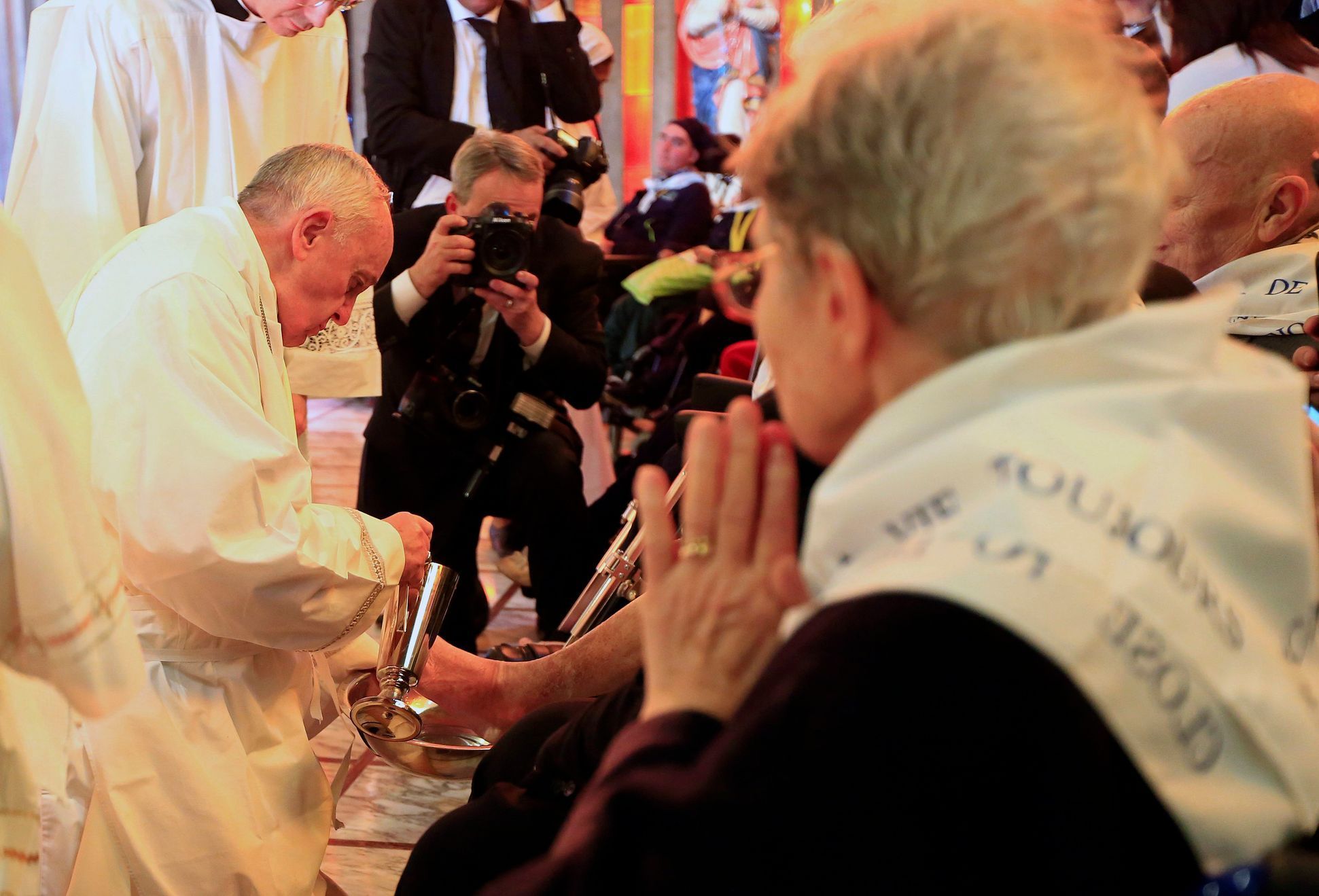 Pope Francis washes a foot of a disabled person at the S. Maria della Provvidenza church in Rome