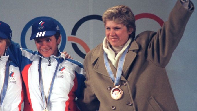 Kateřina Neumannová v kabátu na stupních vítězů v Naganu s Ruskami Larisou Lazutinovou a Olgou Danilovovou