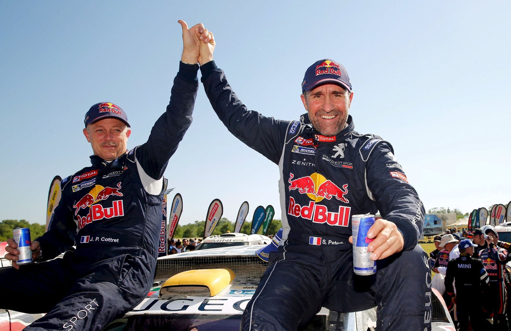 Peugeot driver Peterhansel of France and co-pilot Cottret of France react at the end of the 13th and final stage of the Dakar Rally 2016 in Cordoba province