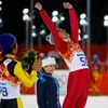 Winner Poland's Stoch is applauded by second-placed Japan's Kasai as he celebrates on the podium during the flower ceremony after his victory in the men's ski jumping individual normal hill final even
