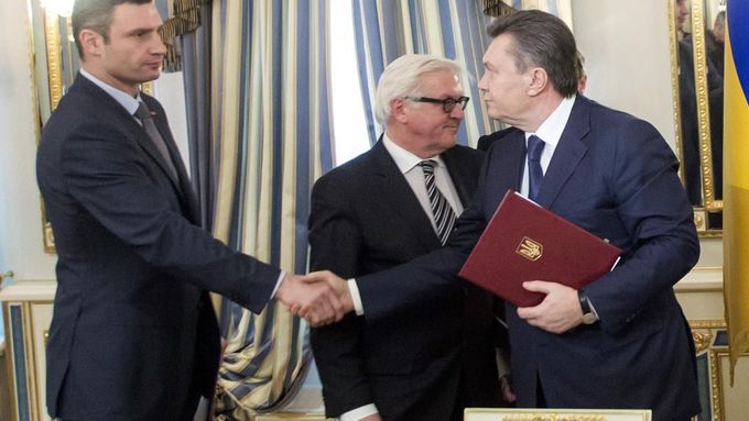 Kličko a Janukovyč se zdraví po podpisu dohody, uprostřed německý ministr zahraničí Steinmeier.
