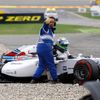 A track marshall gives a thumb up as Williams Formula One driver Massa of Brazil climbs out of the wreckage of his car after crashing in the first corner after the start of the German F1 Grand Prix at