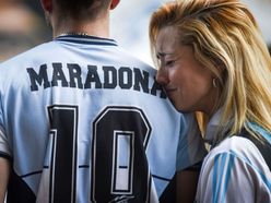 People gather to mourn the death of soccer legend Diego Maradona, outside the Diego Armando Maradona stadium, in Buenos Aires